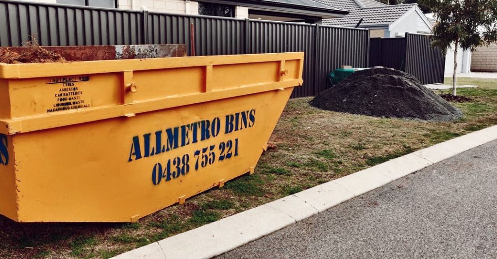 A yellow Perth skip bin outside a residential property.