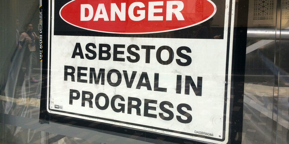 AUCKLAND - AUG 01 2015:Sign reads: Danger - Asbestos removal in progress.Inhalation of asbestos fibers can cause serious and fatal illnesses including lung cancer, mesothelioma and asbestosis.